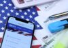 $3M Online Income, Unpaid Taxes Smartphone showing IRS website on top of tax forms and office supplies