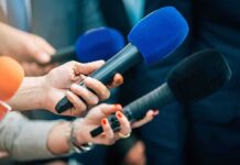Texas Senate Race Gets Culture-War Twist Reporters holding colorful microphones