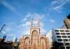 Teen Slashed Inside Brooklyn Synagogue historic brick church with twin towers against blue sky