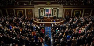 Trump-Era Tax Cuts Face Budget Questions Legislative chamber audience stands and applauds