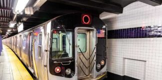 Subway train stopped at an underground station platform
