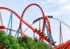 Coaster Horror: Six Flags X2 Faces 100+ Injury Claims Colorful roller coaster with riders on a sunny day