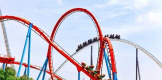 Coaster Horror: Six Flags X2 Faces 100+ Injury Claims Colorful roller coaster with riders on a sunny day