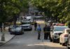 Gunfire Reported Near Notre Dame Game Police officers secure a residential street with patrol cars and yellow tape