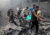Rescuers carry an injured person on a stretcher through rubble