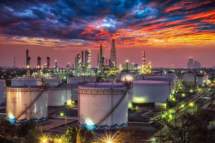 shutterstock_278830388-1 Oil refinery with storage tanks at sunset