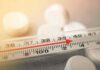 August Breaks Heat Record Glass thermometer with red indicator near 39°C beside white tablets