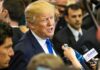 Fox Anchor Gushes: Trump Goes Full Throttle man in suit speaking to reporters with microphones