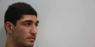 Enes Kanter looking to the side against a plain background