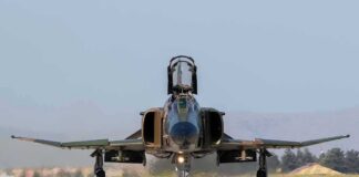 F-16 Crashes During Michigan Training Military jet taxiing on runway with open canopy