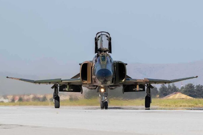 shutterstock_673984819-1 Military jet taxiing on runway with open canopy