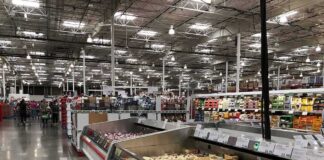Supermarket dairy aisle with refrigerated cheese display cases