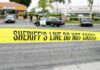 Family Attacked in LA Mall Robbery yellow sheriff's line tape blocks a street near police cars