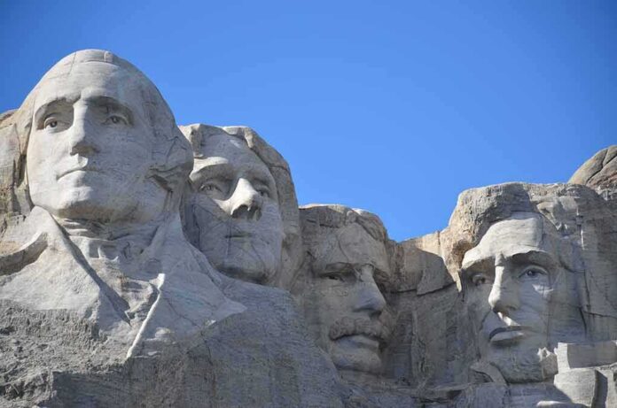 shutterstock_794357455 Mount Rushmore granite sculptures against a clear blue sky