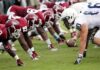 TCU Restores Newspaper Credentials After Reporting Dispute American football players lined up at the line of scrimmage