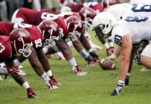TCU Restores Newspaper Credentials After Reporting Dispute American football players lined up at the line of scrimmage