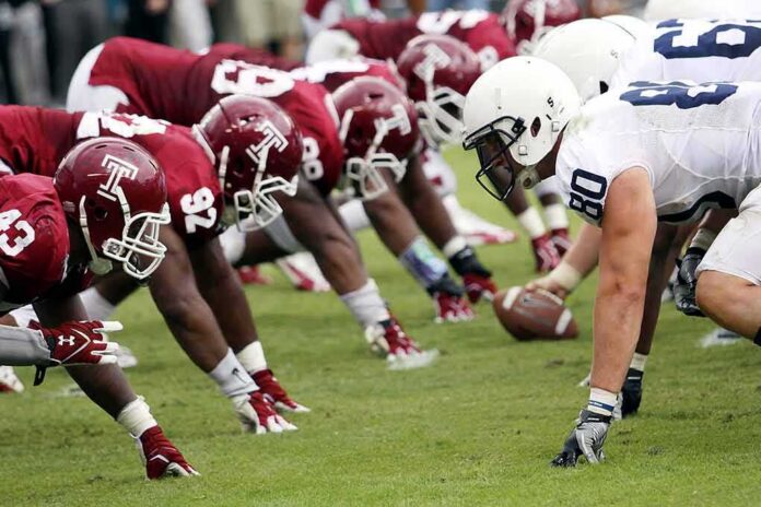 shutterstock_85108498-1 American football players lined up at the line of scrimmage