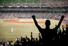 Phillies Clinch Wild Card on Final Day Crowd of fans cheering at a baseball game in a stadium