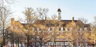 Campus Free Speech Battles Intensify Students relaxing on a campus quad in front of a brick academic building