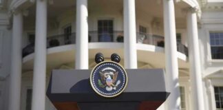 Trump Weighs Firing Ambassador Over $100K Claim Presidential podium with seal in front of white-columned building