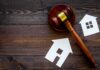 Developer Sues Over 39-Story Menlo Park Project Judge's gavel with paper house cutouts on wooden table