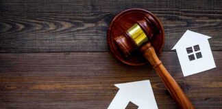 Developer Sues Over 39-Story Menlo Park Project Judge's gavel with paper house cutouts on wooden table
