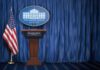 Short White House Briefing Sparks Media Criticism White House press briefing podium with U.S. flag and blue curtain