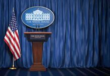 Short White House Briefing Sparks Media Criticism White House press briefing podium with U.S. flag and blue curtain