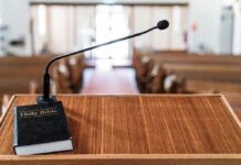 Abortion Debate Ignites Texas Town Hall Podium with microphone and Bible in a church