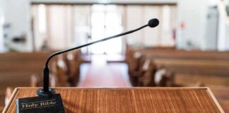 Abortion Debate Ignites Texas Town Hall Podium with microphone and Bible in a church