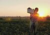 Knife-Wielding Suspect Allegedly Targets Amish Woman Farmer carrying a crate of vegetables at sunset in a field
