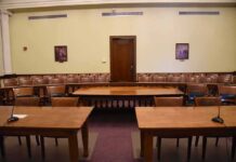 DHS Chief’s Islam Remarks Spark Debate Empty courtroom with wooden tables and gallery seating