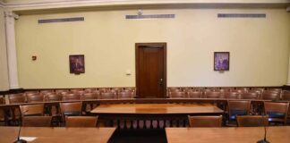 DHS Chief’s Islam Remarks Spark Debate Empty courtroom with wooden tables and gallery seating