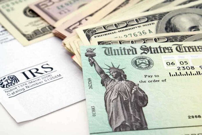 shutterstock_13772947 A tax refund check from the IRS alongside various denominations of cash
