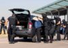 Man Arrested by ICE After Earlier Virginia Charges customs officers detain a person beside a car with its trunk open