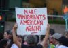 Teddy Williams at a protest holding a sign reading 'Make Immigrants American Again'