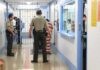 California Sanctuary Policy Sparks Public Safety Debate Corrections officers escort an inmate in a jail hallway