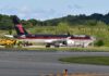 Trump Flies to Rally With Boxing Legend Private jet with black and red livery parked on airport tarmac