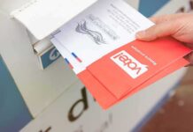 California Ballots Face Federal Challenge Hand dropping mail-in ballots into a drop box