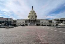 United States Capitol building with dome under a partly cloudy sky