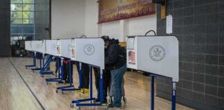 Citizenship Checks Spark Election Showdown Voters at polling booths in a gymnasium