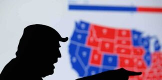 Iowa, Ohio and Kansas Senate Races Remain Close silhouetted person pointing in front of a U.S. election map