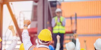 construction workers raising fists during a safety briefing