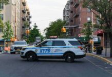 One-Year-Old Killed in Queens Stroller Crash NYPD police SUV blocking a city street at a taped-off scene