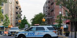 One-Year-Old Killed in Queens Stroller Crash NYPD police SUV blocking a city street at a taped-off scene