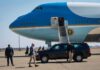 Trump Hints at Possible New Summit With Kim Jong Un Security detail near blue and white aircraft with staircase and SUV