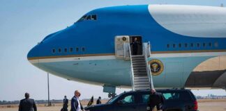 Trump Hints at Possible New Summit With Kim Jong Un Security detail near blue and white aircraft with staircase and SUV