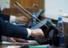 Russian Nuclear Threat Puts UK on Alert Person pressing a button on a conference microphone panel