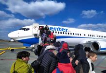 Pilot Stabbing Sends Jet Into Emergency Passengers boarding a commercial airplane via mobile stairs