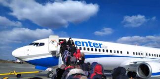 Pilot Stabbing Sends Jet Into Emergency Passengers boarding a commercial airplane via mobile stairs